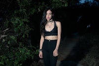 a woman wearing black pants and a black crop top