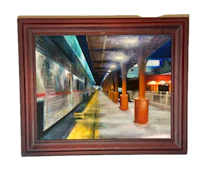 a painting of a train station in a wooden frame