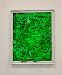 a white frame with green paint on it