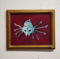 a painting of a dog on a red wall