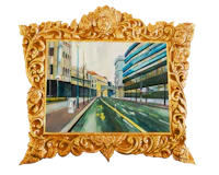 a painting of a city street in a gold frame